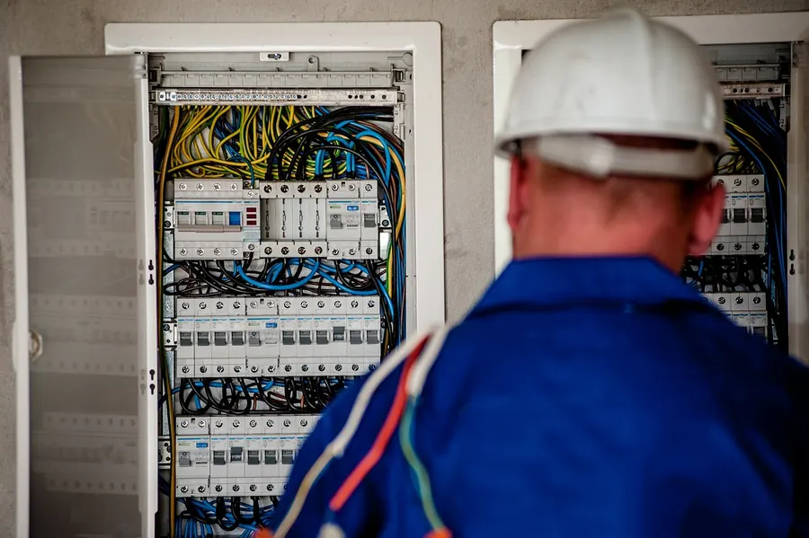 Electrician testing a circuit during a maintenance inspection